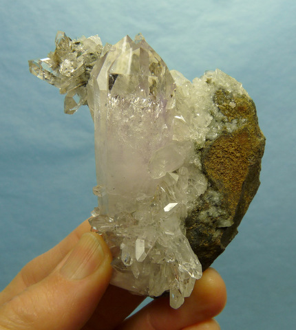 Clear quartz crystal with smoky / amethyst phantom and hematite inclusions