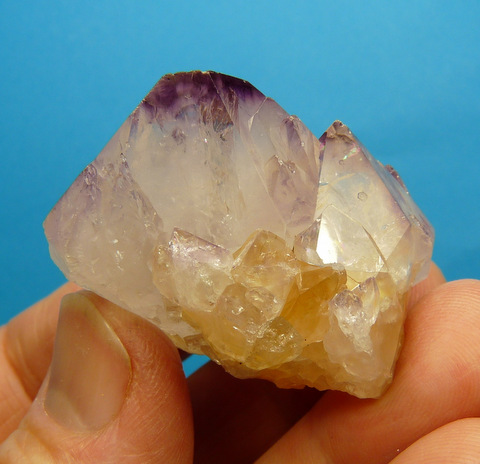 Whitish quartz crystal group with amethyst patches
