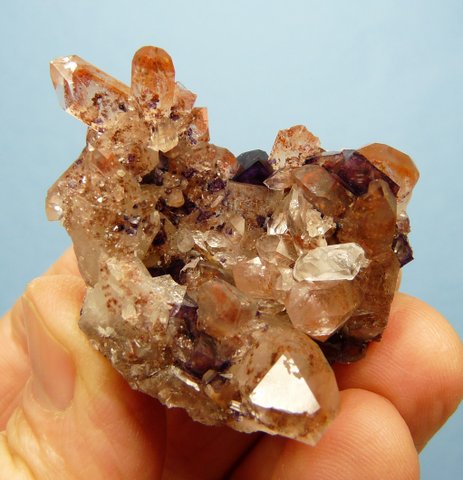 Phantom quartz cluster with distinct orangy-red phantoms