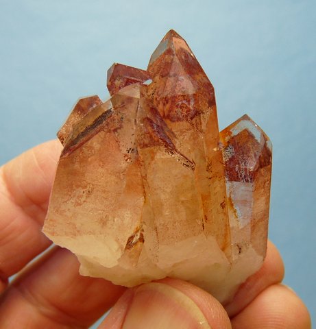 Clear quartz crystal with distinct orange / red phantom
