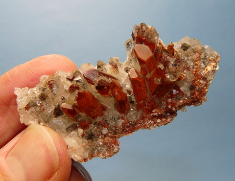 Druse of quartz crystals with lovely red / brown phantoms