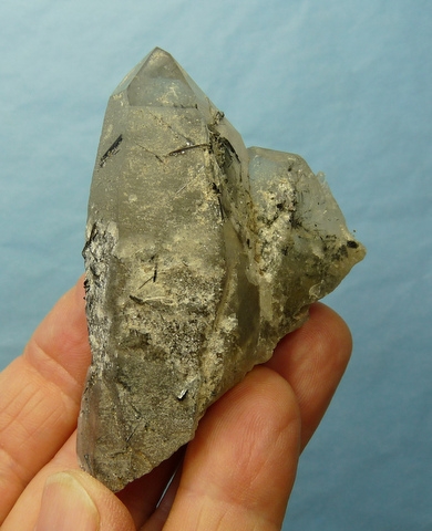 Group of quartz crystals with schorl in and on it