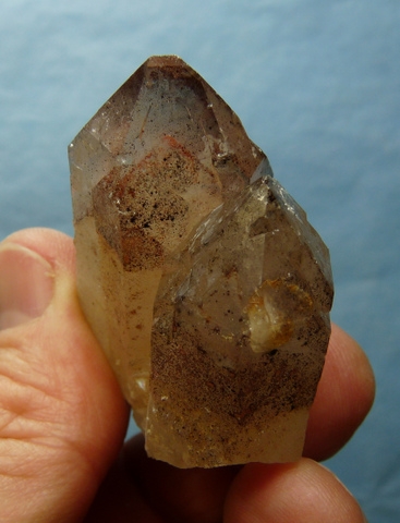 Quartz crystal specimen with hematite inclusions