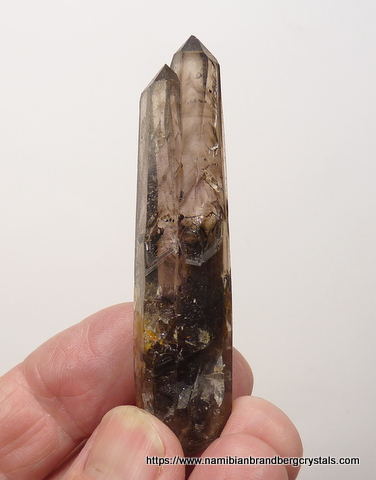 Twinned smoky quartz crystals with negaitve crystal inclusions