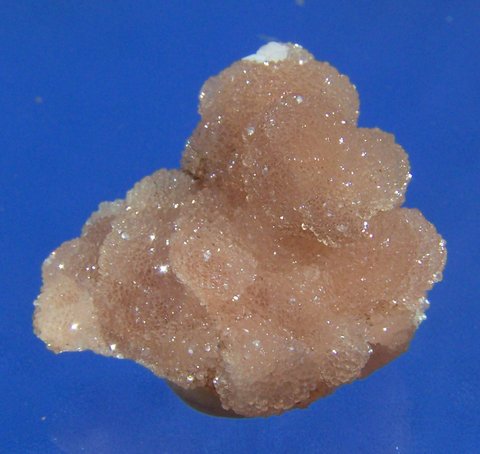 Cluster gemmy peach / camel coloured olmiite aggregates