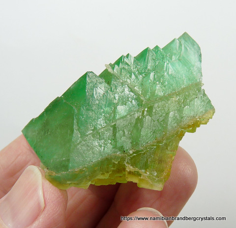 Green fluorite crystal with natural cracks, fused with minute fluorite crystals