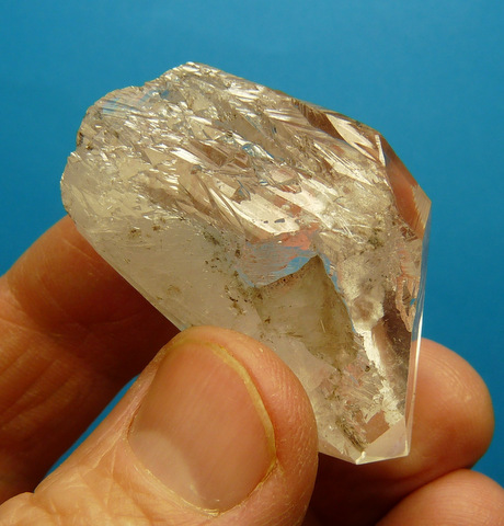 A stubby quartz crystal floater with lovely growth patterns