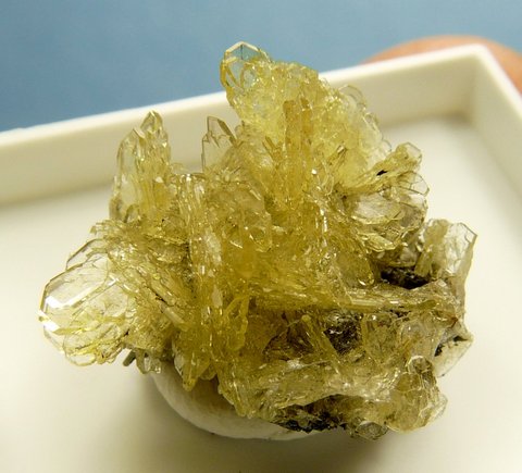 Delicate cluster of pale yellow bladed barite crystals