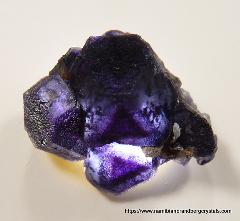 Purple fluorite crystal group with light from behind