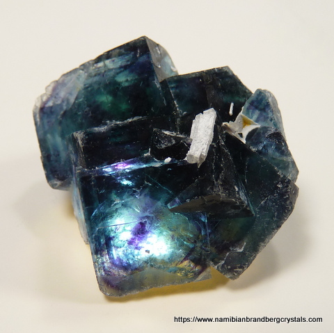 Blue-green fluorite crystal group with light from behind